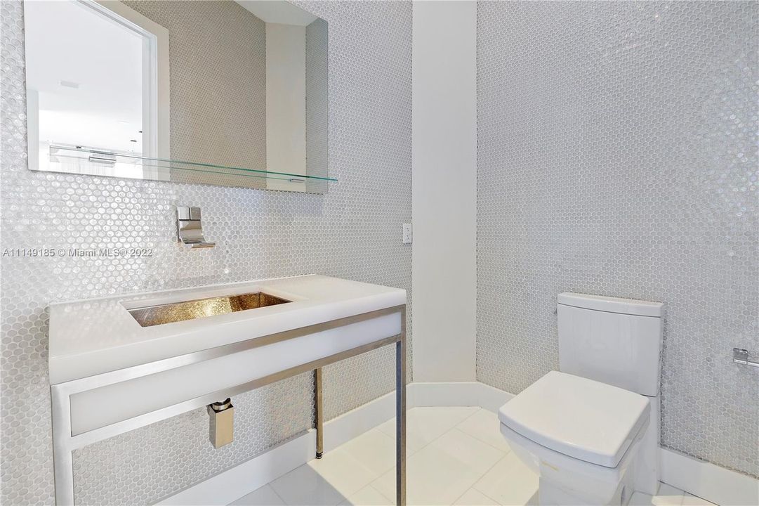 A beautiful mosaic half bath for guests off the living/dining area.