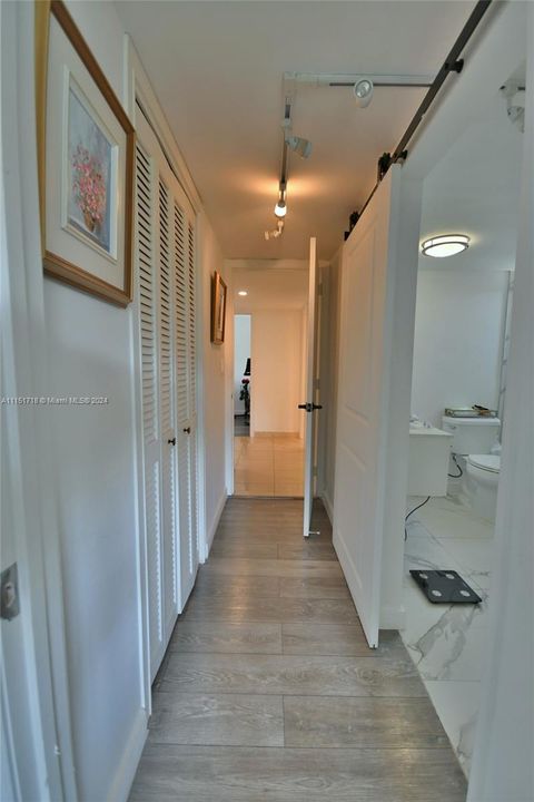 Master/Priimary Hall walk-in on the left and EnSuite on the right with a Barn Door