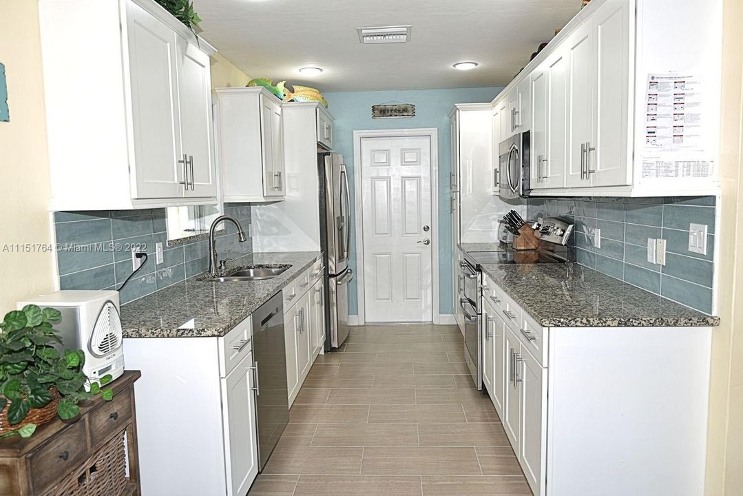 Plenty of counterspace for the gourmet chef. Tile wood like flooring