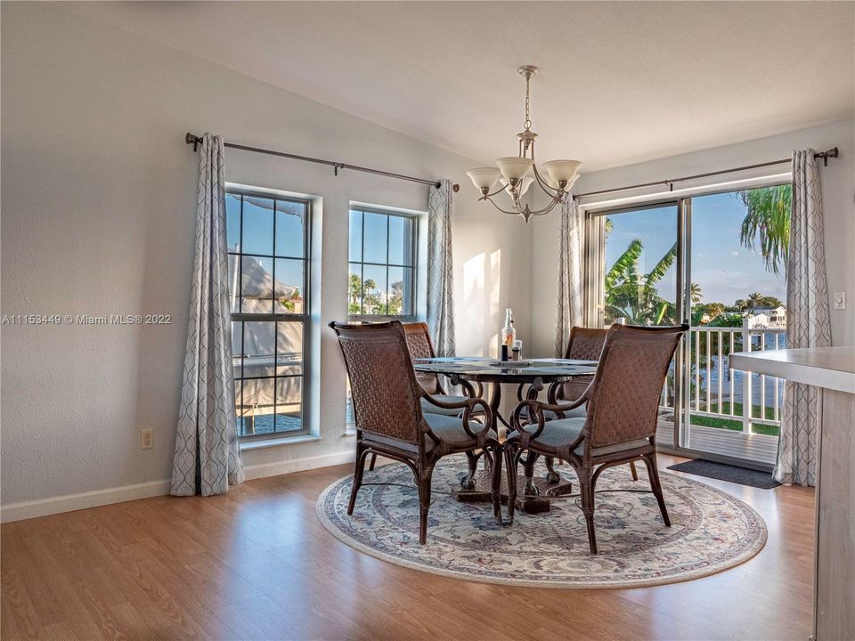 Dining room with panoramic views of water. sliders to new trex deck porch and paver patio