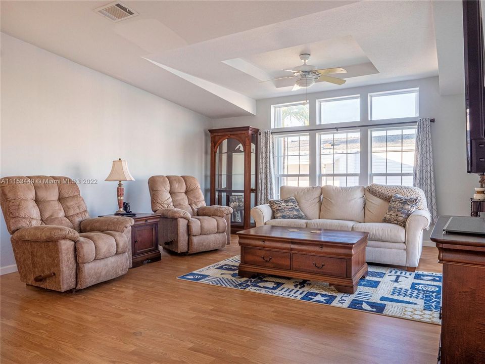 Living room with vaulted ceilings and floor to ceiling windows