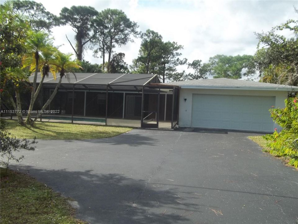 Front view - Pool area & 2 car garage