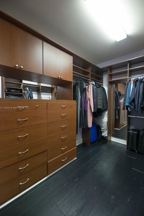 ONE OF THE CUSTOM WALK-IN CLOSETS IN OWNERS SUITE