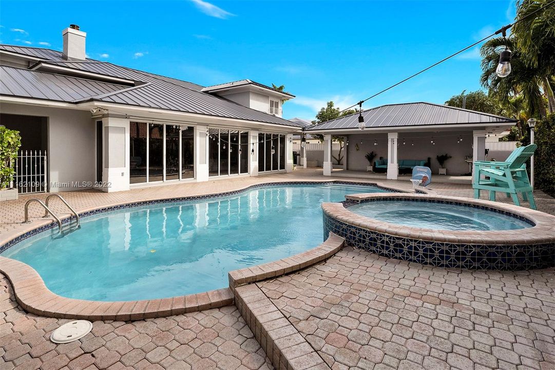 Backyard with saltwater pool and roofed patio