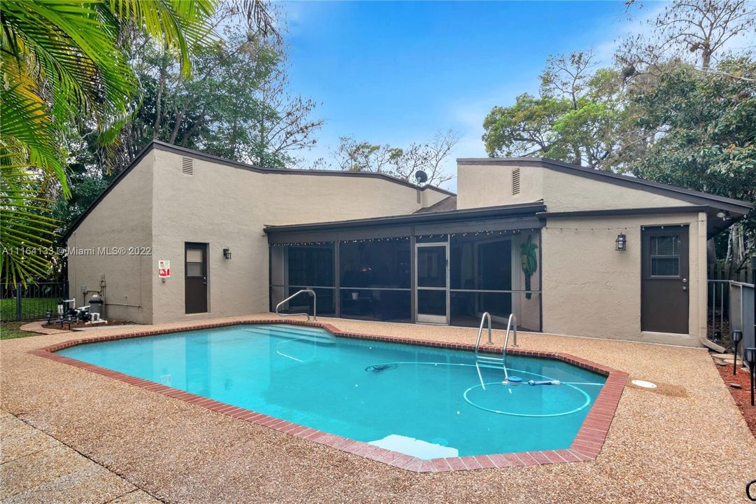 Lovely pool surrounded by lush, tropical trees and fully fenced.