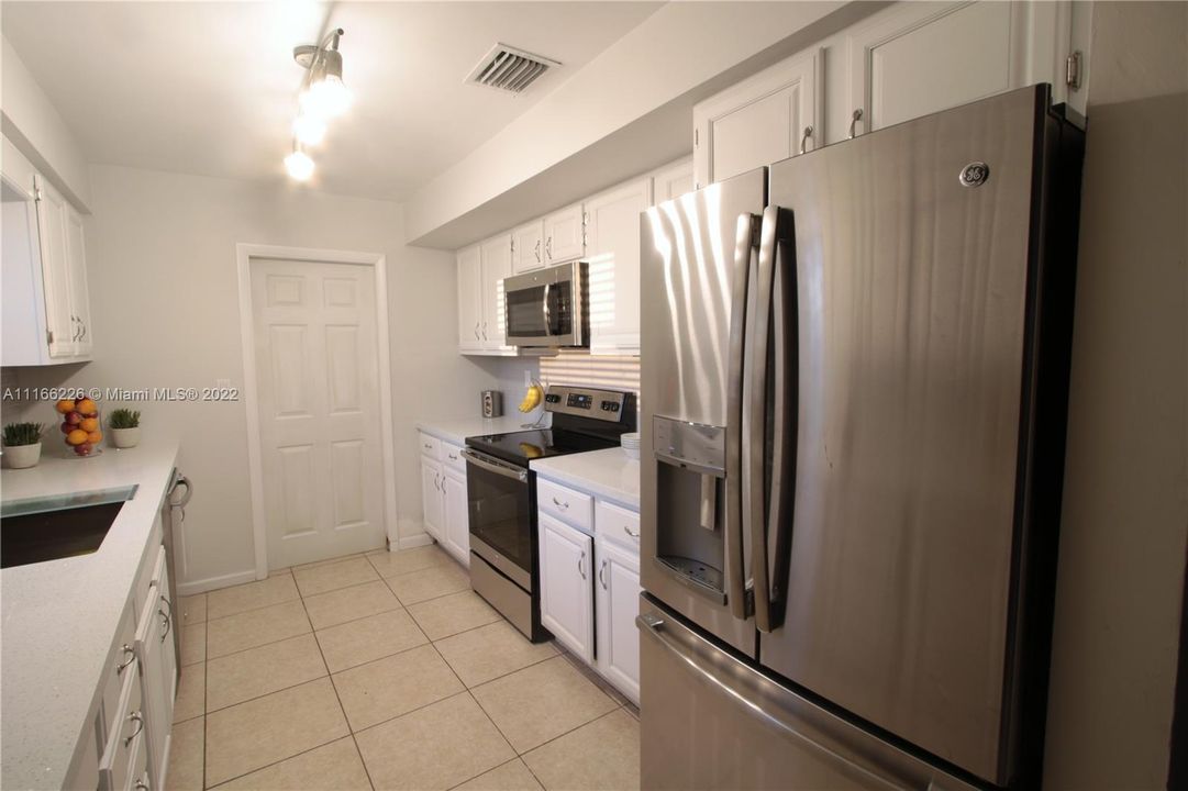 Kitchen with door to garage and laundry