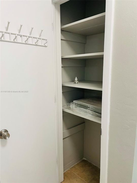 Linen closet in hallway to bedrooms