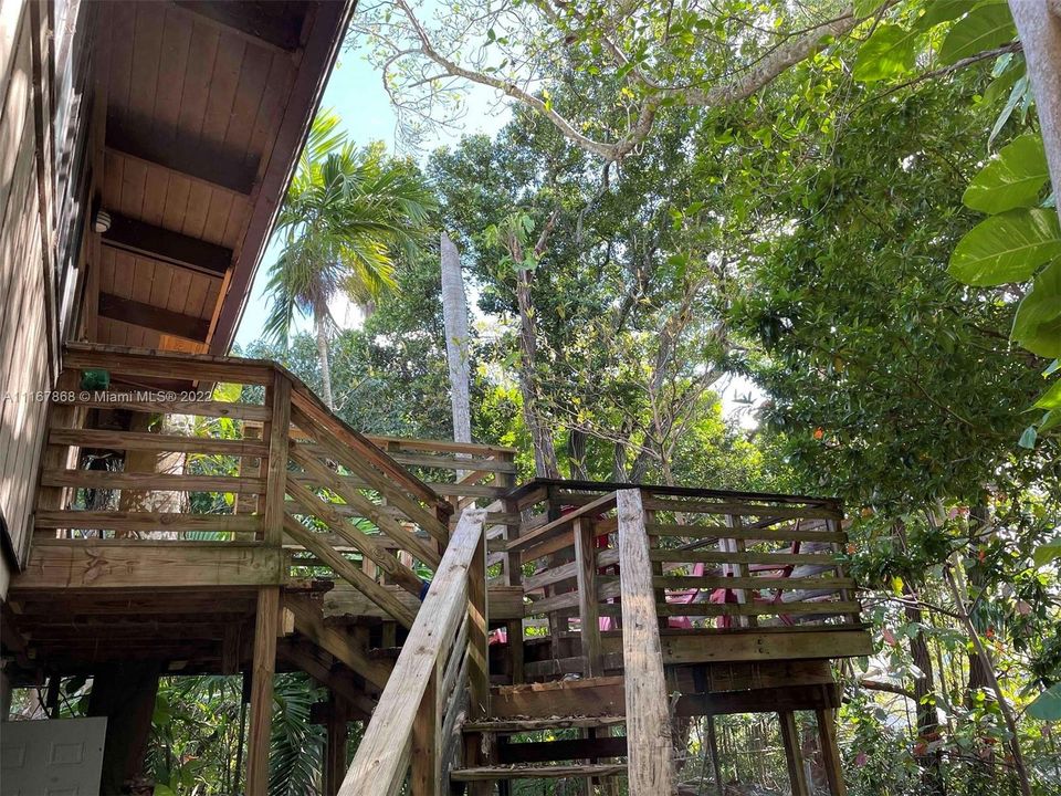 stairs to living area upstairs with deck.