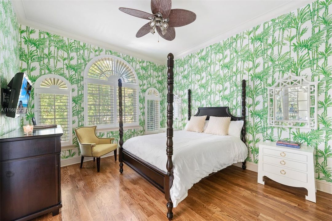 Guest bedroom with full bath, plantation shutters and gorges tropical wallpaper, perfect for guests.