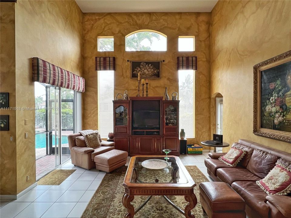 Family Room - Grand Ceiling, Filled with Natural Light, Sliding Glass Doors to Patio with Pool and Lake Views