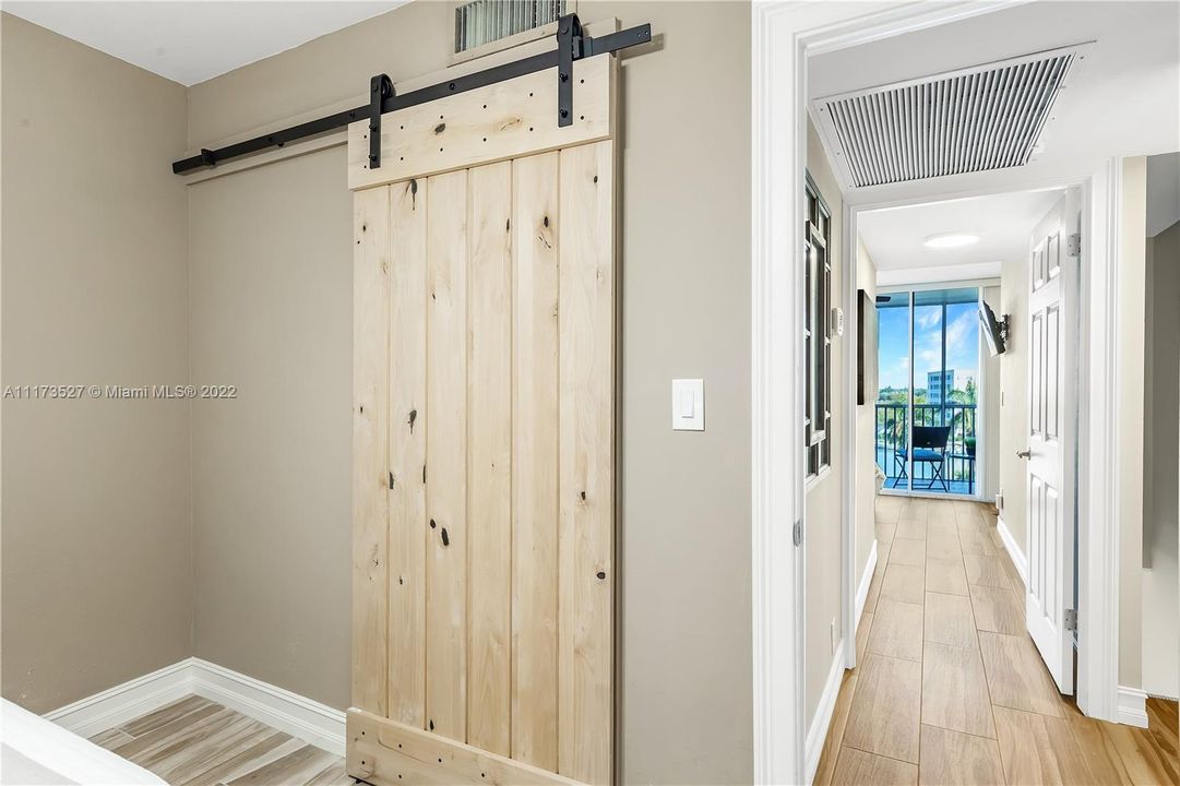 Modern barn door look to bathroom in 2nd bedroom