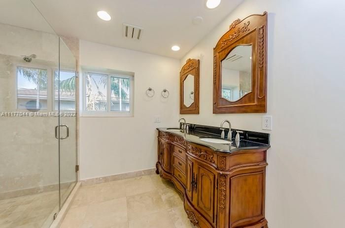Master Bath has double sinks a large frameles walk-in Shower and a private toilet area.