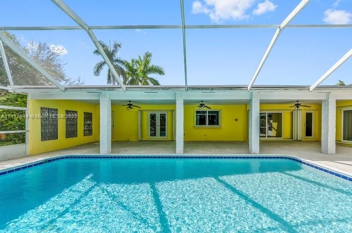 View of the Pool-Patio looking towards the back of the house. Also notice that in addition to impact glass windows and doors the East side of the house has accordion shutters for TWICE THE PROTECTION in a tropical storm! The NEXT PICTURE IS SO VALUABLE to a young Family!!