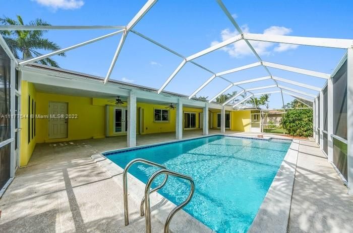 Ahhhh South Florida is wonderful! The kids will be in the POOL on Christmas morning most years! Wide covered patio for all the patio furniture to be outside and usually stay dry! The white door to the left is another strorage area for pool supplies, toys and the children's safety fence!