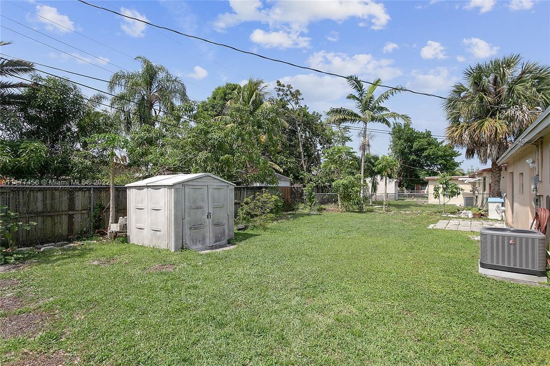Huge fenced backyard with room for pool & for planting fruit trees