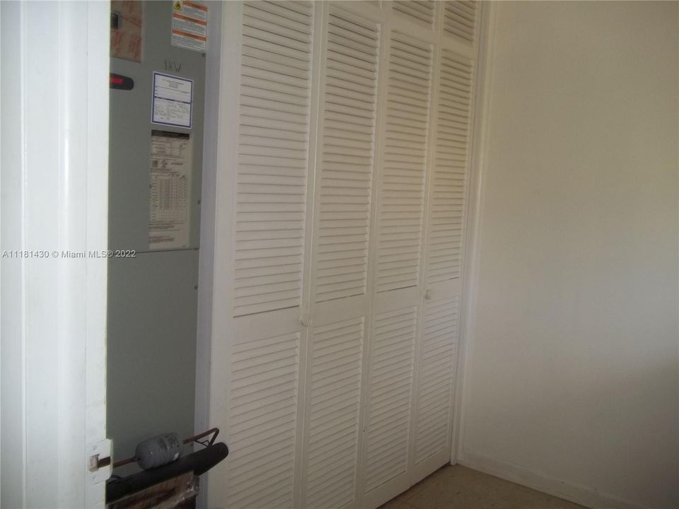 Storage closet & a/c air handler in laundry room