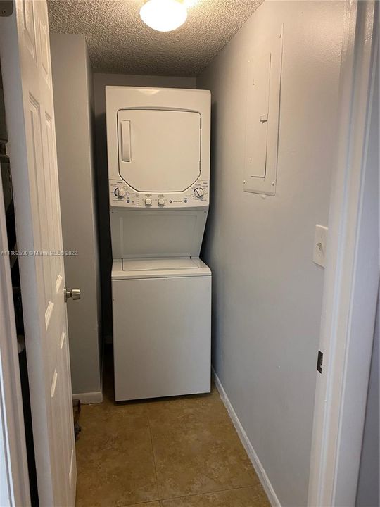 Utility room with brand new water heater. Washer/dryer in unit