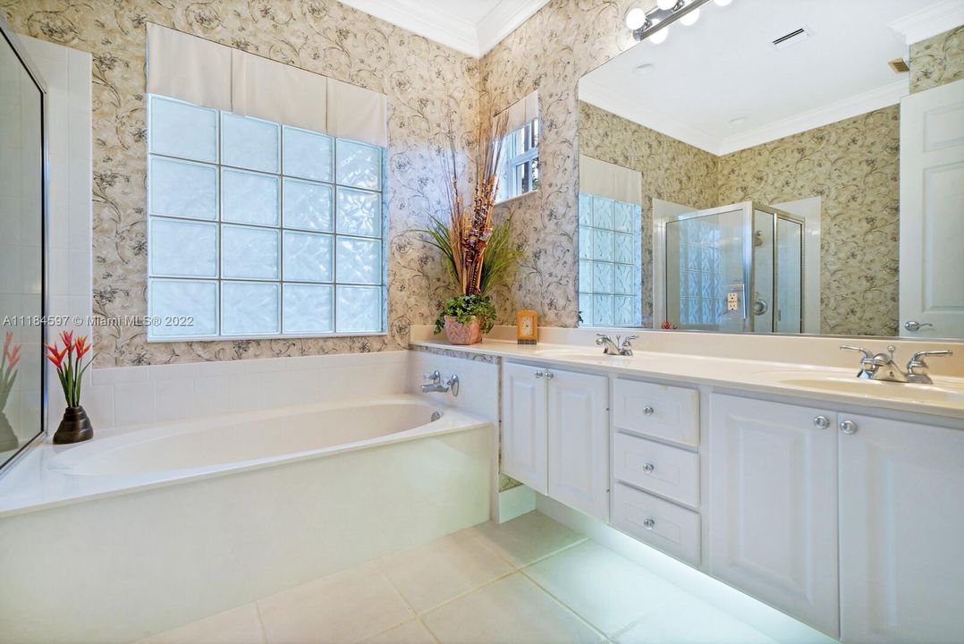 master bathroom with glass block window, dual sinks