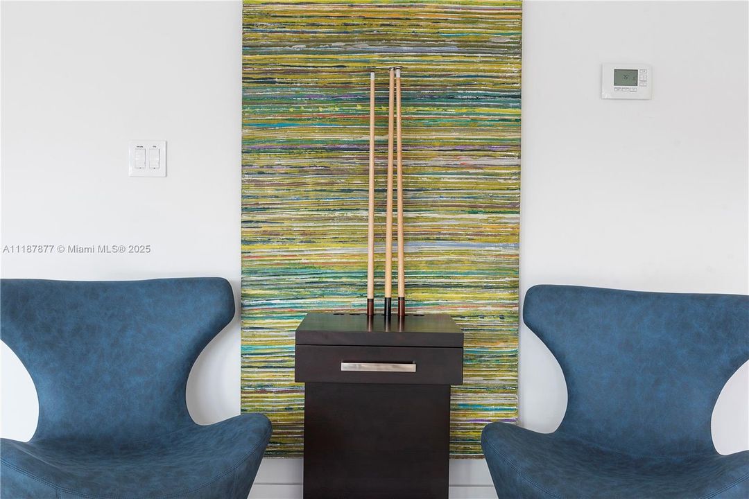 Cue rack nook with twin blue chairs