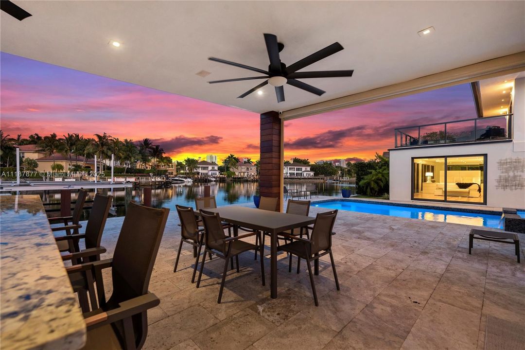 Patio dining with fans and pool views