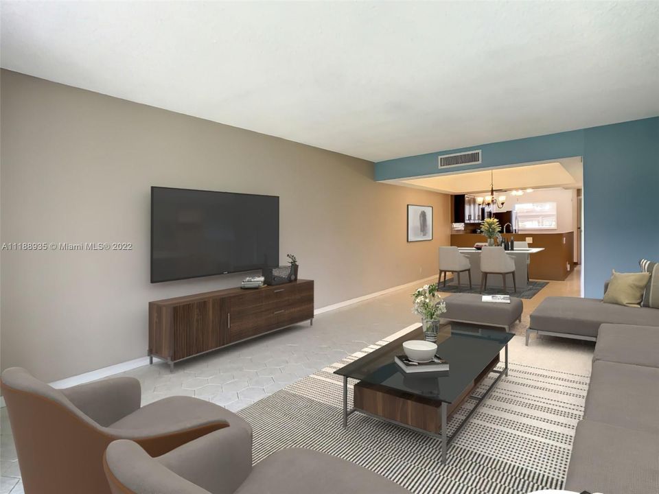 This virtually staged modern living room has an open floor plan and is connected to areas such as the kitchen & the dining room. This allows them to feel open, bright and spacious. The spaces are often visually delimitated but without using walls.