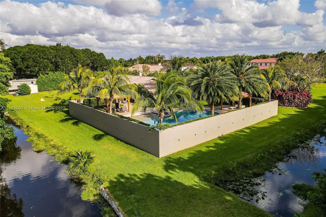 NW of property, wall surrounding pool area