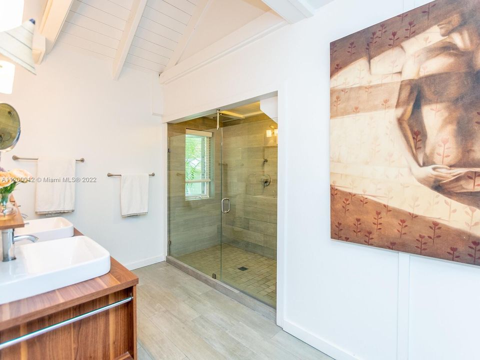 The main bathroom offers dual sinks and a expansive shower.