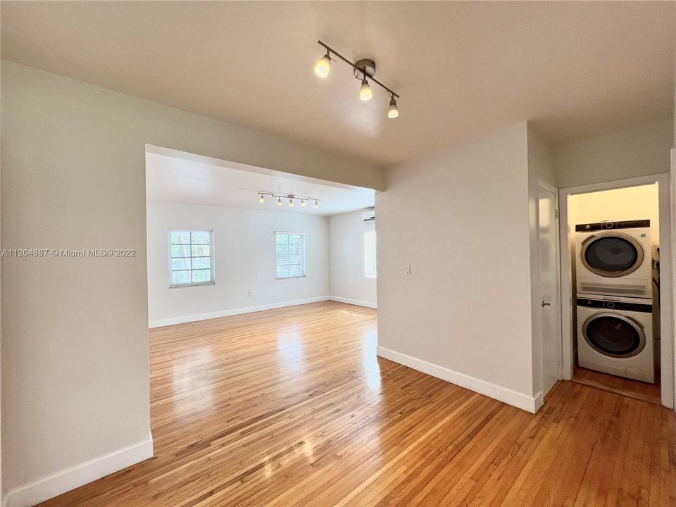 Living Room / Dining Area, with beautiful wood floors, and brand new washer dryer inside the unit.