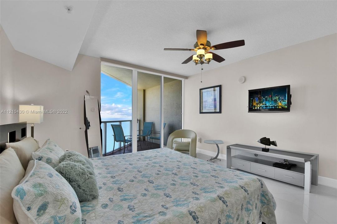 master bedroom with a private balcony and ocean views!!