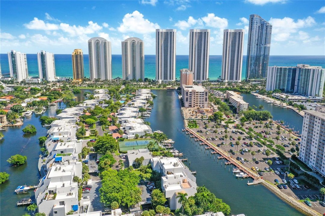 This gated 13 acre community has 190 units on the private  Poinciana Island in Sunny Isles Beach. Picturesque and views of water throughout, this island has many amenities including the following: 2 Heated Adult Pools, 1 Kiddie Pool, a gym that is currently being upgraded to have floor to glass ceiling windows facing the water, a sauna, a party room, clubhouse, basketball courts, a soccer field, 4 tennis courts and 24 hour security.