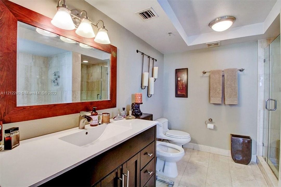 En Suite master bathroom with upgraded double vanity/mirror, all glass shower doors, and Jacuzzi tub.