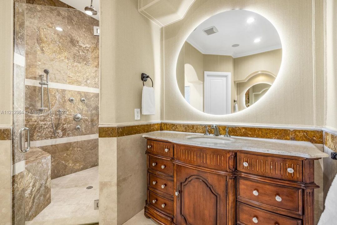 Dual vanities and huge shower stall with wall jets.