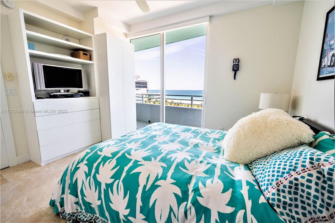The guest bedroom has access to (and views of!) the balcony, and also built-in cabinets and electronic black-out blinds.