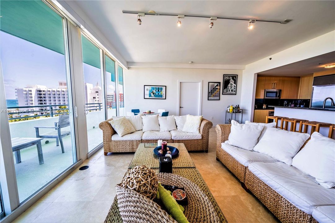 The light-washed living area is comfortably furnished with a beachy vibe