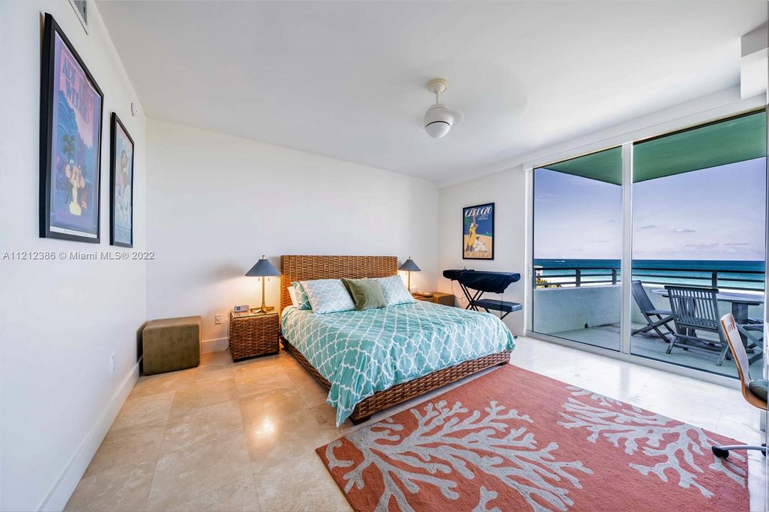 The primary bedroom opens off of the living areas, and also has access to the balcony and sweeping views of the Atlantic Ocean.  There are electric blackout shades mounted over the glass doors in the event one wishes to "sleep in"