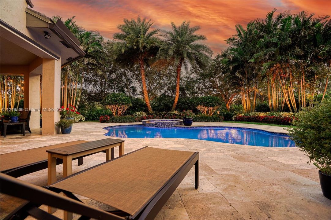 Backyard landscape lighting creates a tropical oasis.