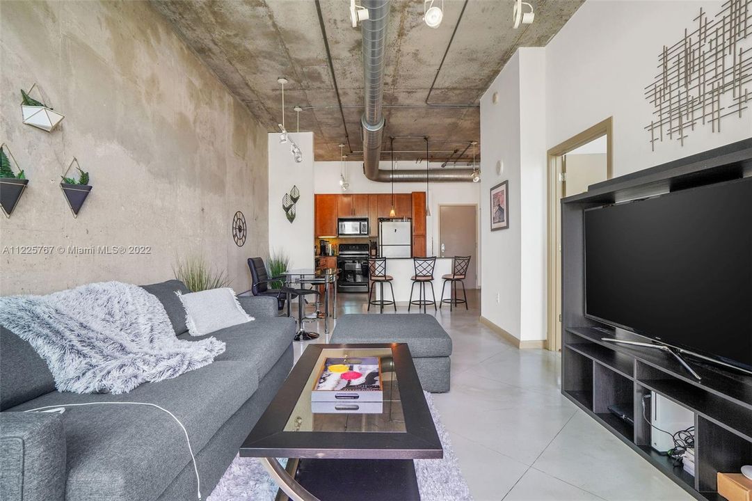 11 ft soaring ceilings, exposed ductwork, natural concrete wall boundary wall