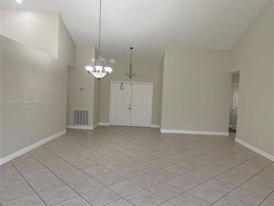 Looking towards the front door from living room and dining room