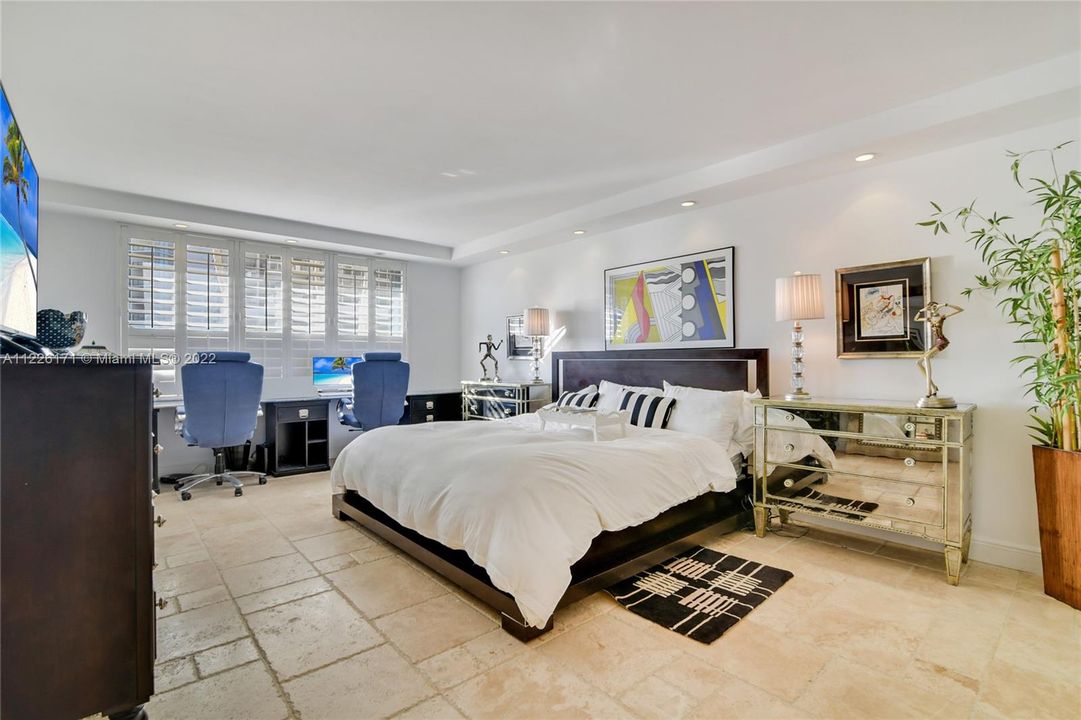 A very large Master Bedroom with desk space for two.