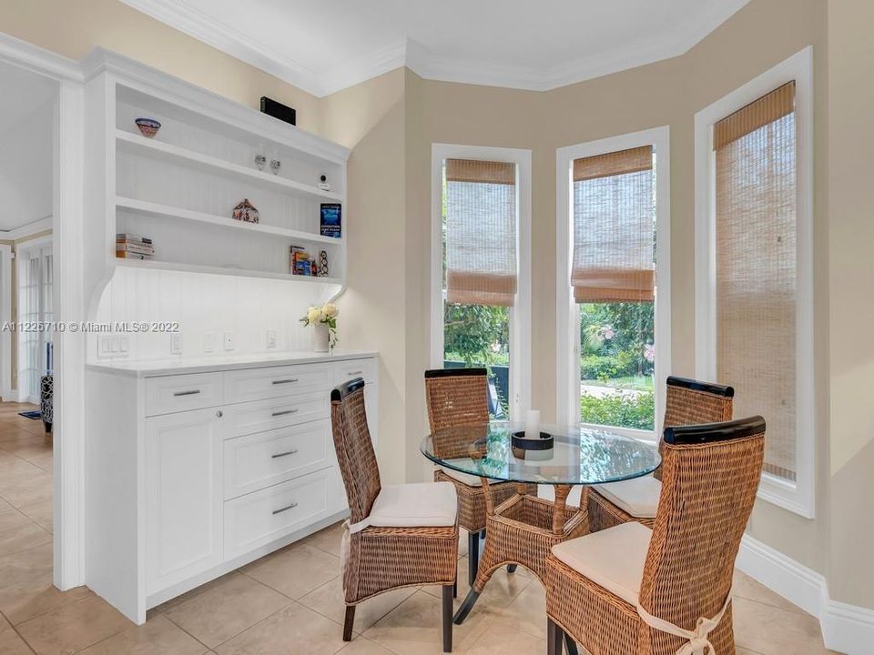 Cozy breakfast nook  for a perfect start of your day, is nestled between The custom cabinets custom cabinetry and the bright bay window. Let the sun shine in!