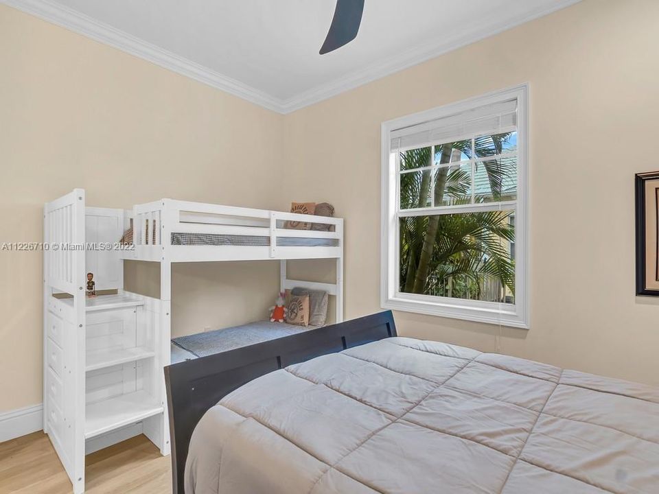 Guest bedroom is spacious enough for several family members or guests. Furnished here with Queen and bunk beds shows you the size of this large room.