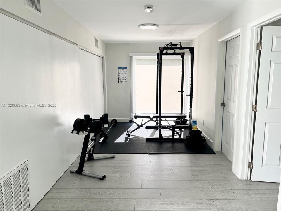 Lower level Gym space with spacious storage clostes