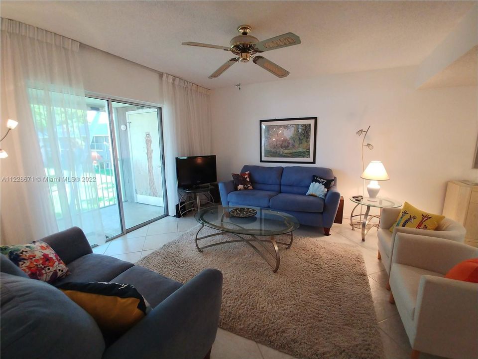 Lovely living room area opens to your screen balcony.