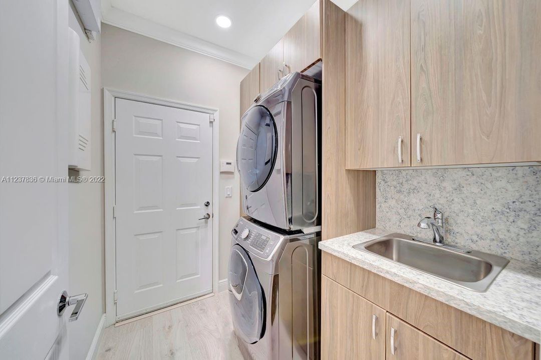 Laundry room with lots of storage.  With door to 2 car garage attached.