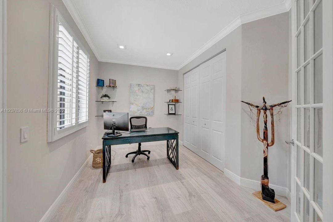 French doors open up into a spacious bedroom.