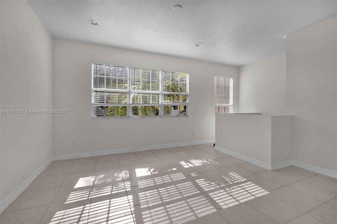 2nd floor has extended living room and sunkin lights. View of front patio from windows. Great sunlight