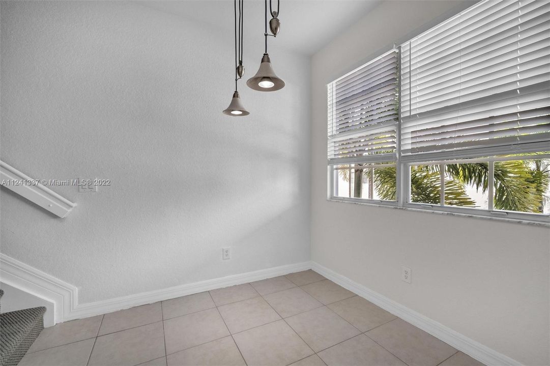 Formal dining room. Great sunlight comes through these windows. 1/2 bath not in photo but close.