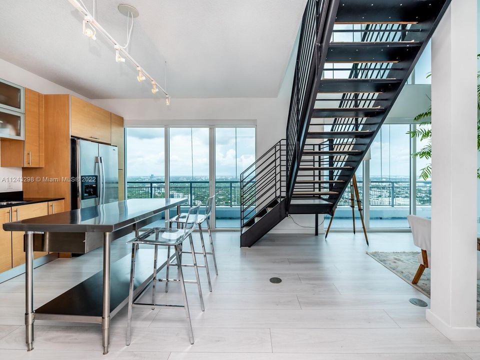 Kitchen with Floor to ceiling glass doors and windows with spectacular unobstructed views.
