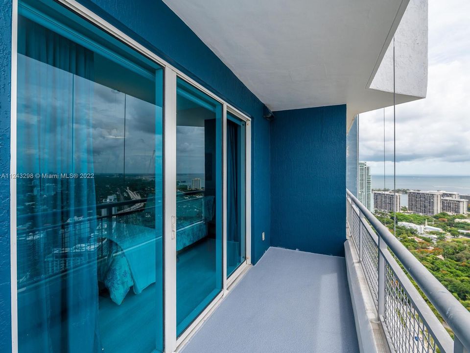 Floor to ceiling glass door and window overlooking unobstructed views of Miami's gorgeous skylines.