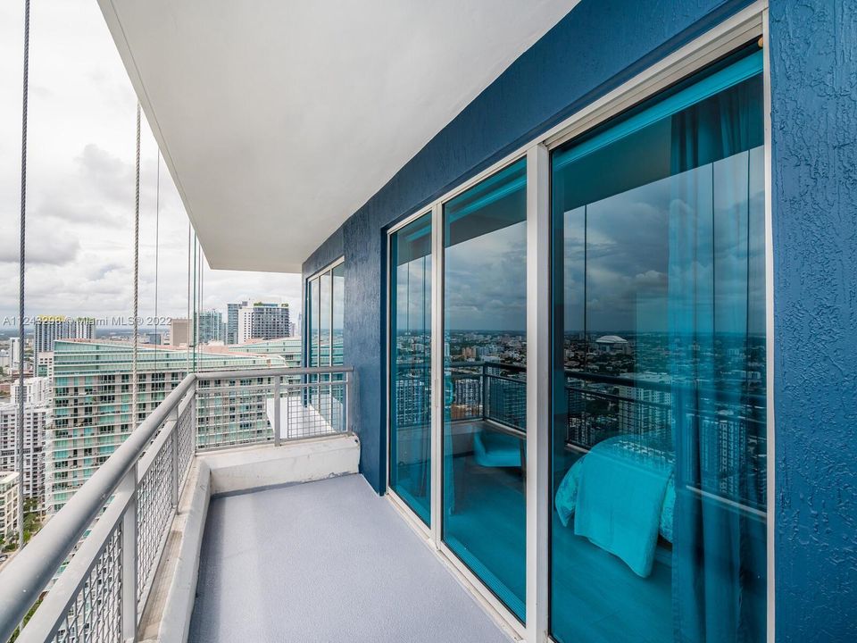Floor to ceiling glass door and window overlooking unobstructed views of Miami's gorgeous skylines.